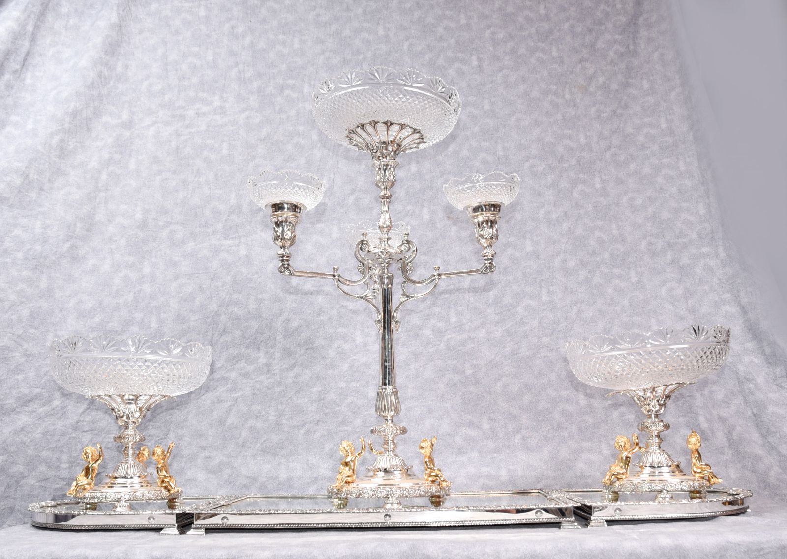 Some of these centrepieces can be adapted to house a silver plate candelabra to the centre