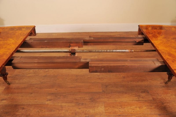 The inners of an extending antique dining table with metal winding mechanism