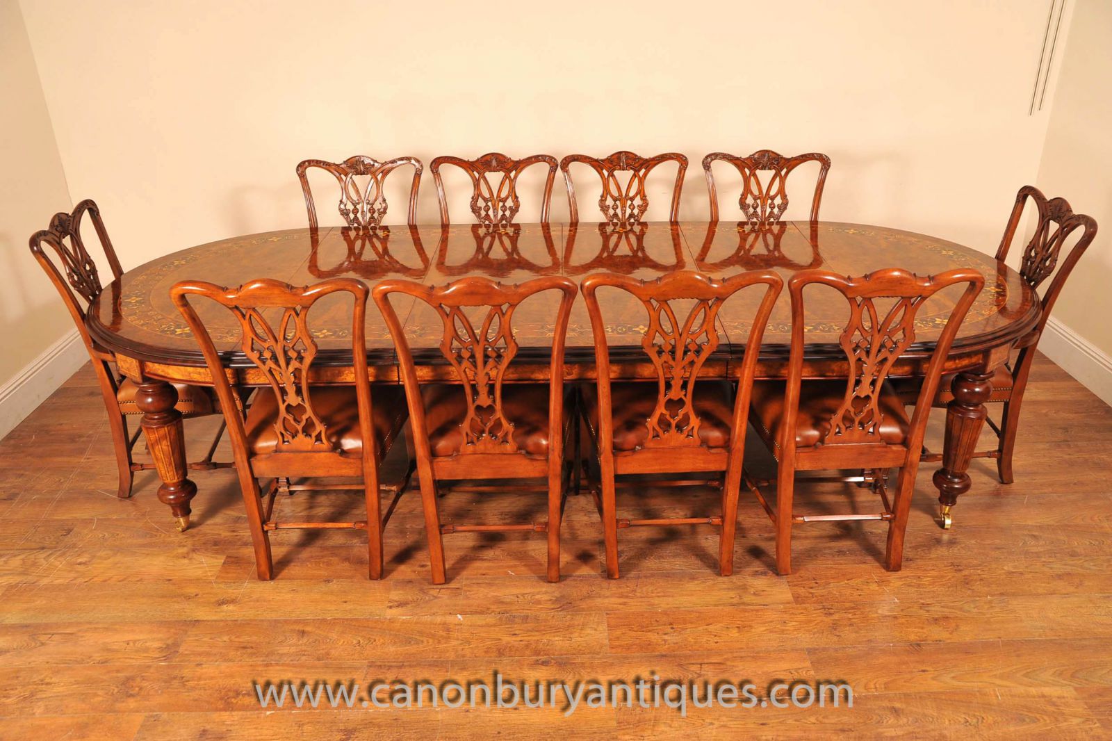 Walnut Victorian dining table with marquetry inlay and set of matching chairs
