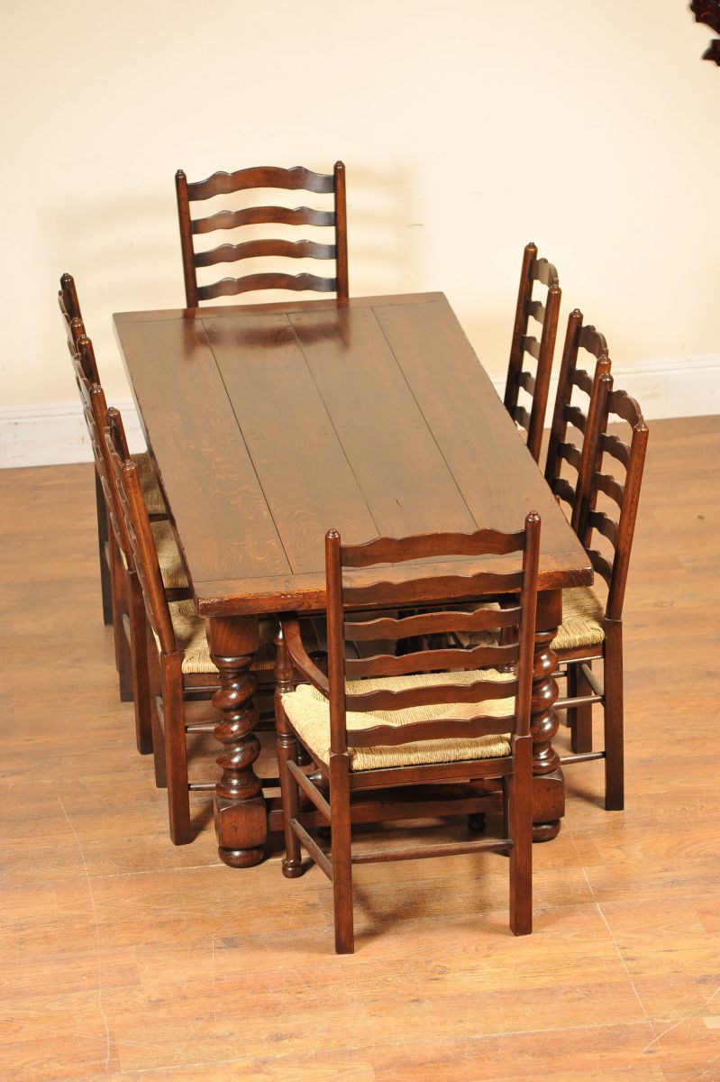 Set of ladderbacks around a matching oak refectory table with barley twist legs