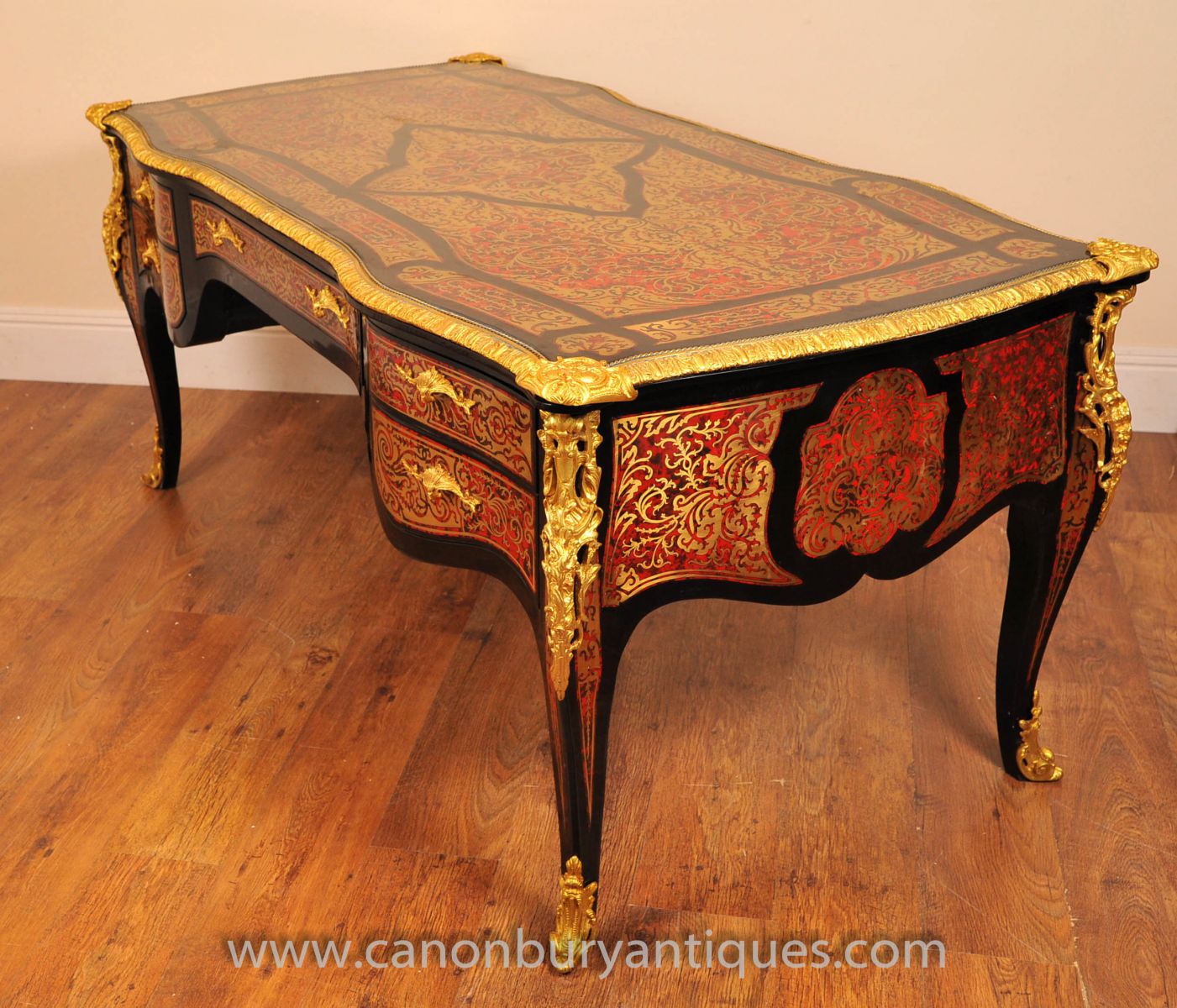 A Boulle desk, characterised by the distinctive brass, ebony and tortoise shell inaly work
